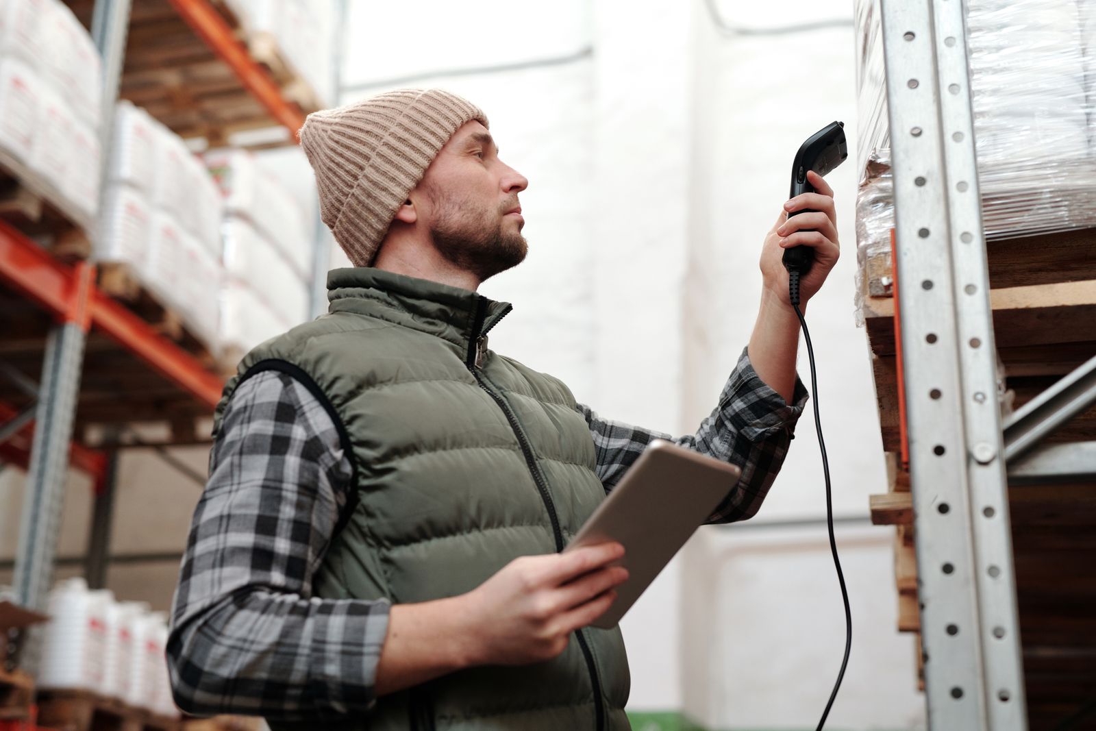 Warehouse operator scanning inventory against a digital record
